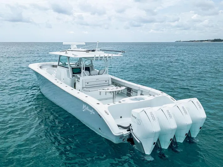  Yacht Photos Pics 2019 Yellowfin 42 boat with triple outboard engines on clear blue water.