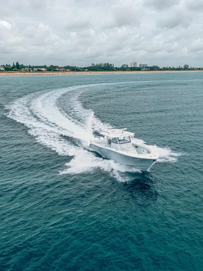  Yacht Photos Pics 2019 Yellowfin 42 boat cruising on open water near a coastline.