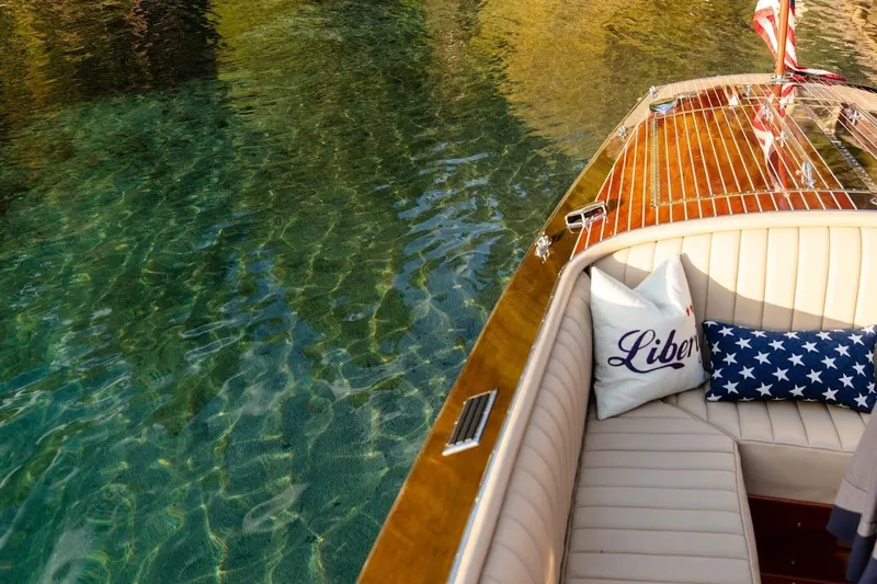 Liberty 1776 Yacht Photos Pics Luxurious 2007 Hacker-Craft 32 Sportabout boat on clear water, featuring elegant seating and decorative pillows.