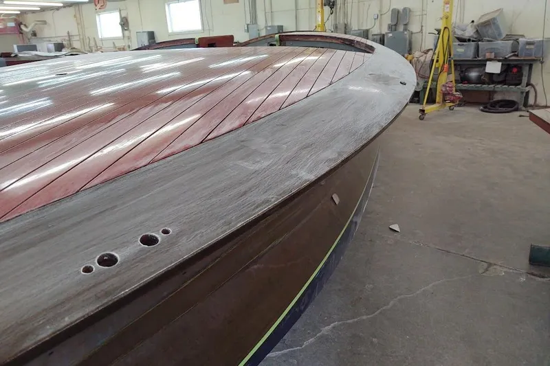 Liberty 1776 Yacht Photos Pics 2007 Hacker-Craft 32 Sportabout boat in workshop, showcasing wooden deck and hull details.