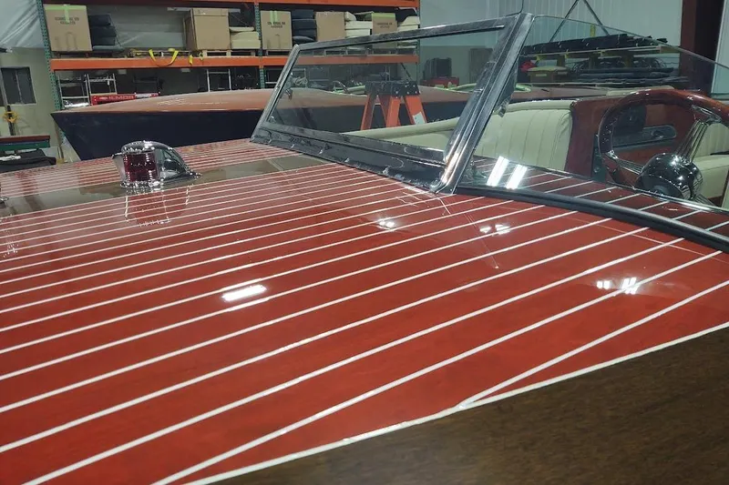 Liberty 1776 Yacht Photos Pics 2007 Hacker-Craft 32 Sportabout with polished wood finish and chrome details in a workshop.