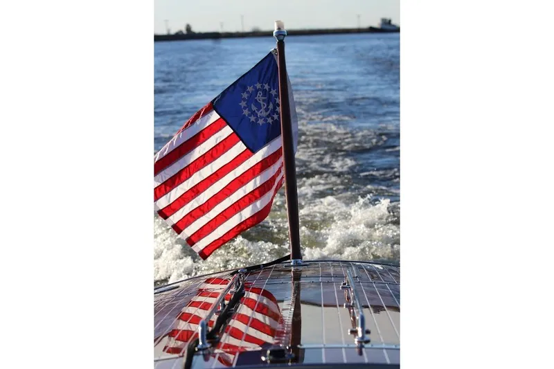 Liberty 1776 Yacht Photos Pics Hacker-Craft 32 Sportabout 2007 with American flag on water.