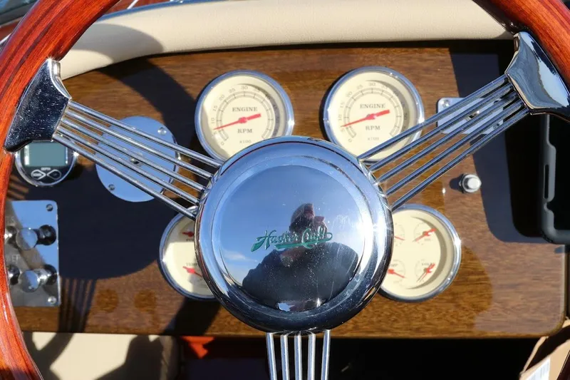 Liberty 1776 Yacht Photos Pics Steering wheel and dashboard of 2007 Hacker-Craft 32 Sportabout boat, featuring classic gauges.