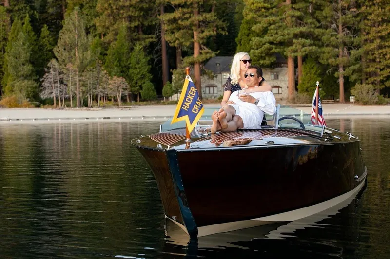 Liberty 1776 Yacht Photos Pics Couple relaxing on a 2007 Hacker-Craft 32 Sportabout boat on a serene lake.