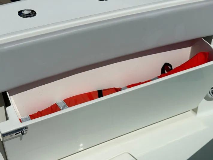  Yacht Photos Pics Storage compartment on 2018 SeaVee 390Z boat with red life jacket inside.