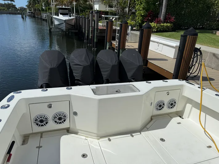 Yacht Photos Pics 2018 SeaVee 390Z boat with quad engines docked by a waterfront.