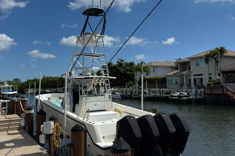  Yacht Photos Pics 2018 SeaVee 390Z boat docked in a sunny residential canal.