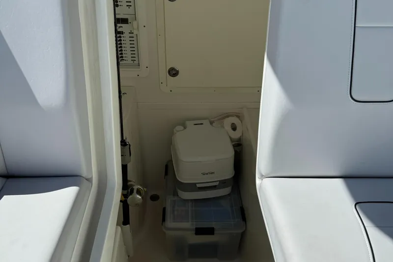  Yacht Photos Pics 2018 SeaVee 390Z interior storage area with portable toilet and containers.