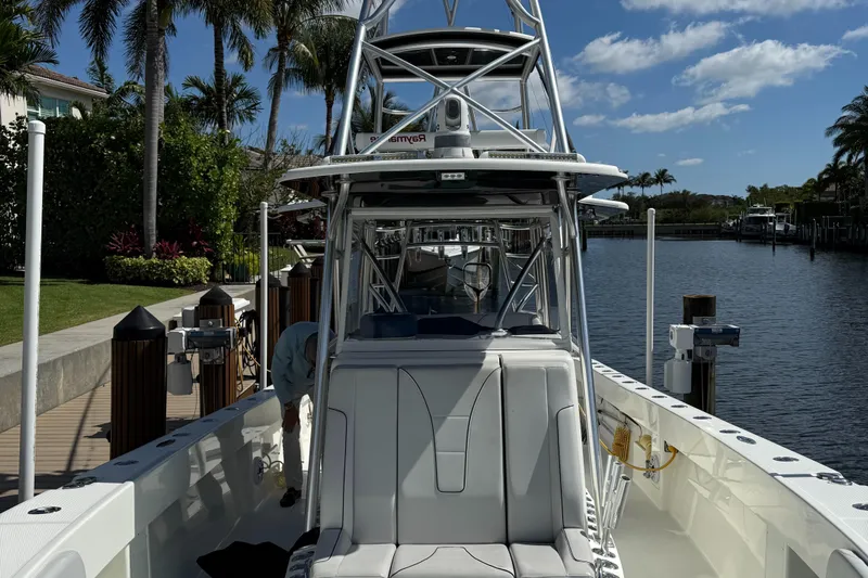  Yacht Photos Pics 2018 SeaVee 390Z boat docked by a tropical waterfront with palm trees.