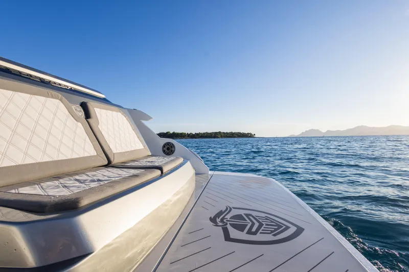  Yacht Photos Pics 2025 Canados 571 yacht on open sea with clear sky and distant islands.