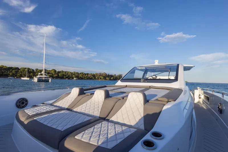  Yacht Photos Pics Luxurious 2025 Canados 571 yacht with sunbathing deck on serene water.