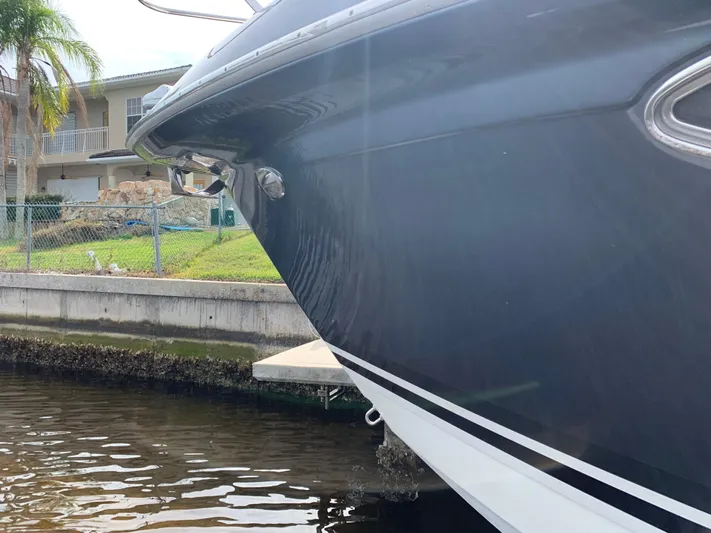 The Great Escape Yacht Photos Pics 2017 Formula 34 Cruiser docked near a waterfront property.