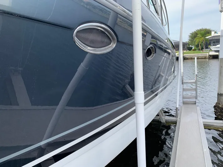 The Great Escape Yacht Photos Pics 2017 Formula 34 Cruiser docked at marina, side view.