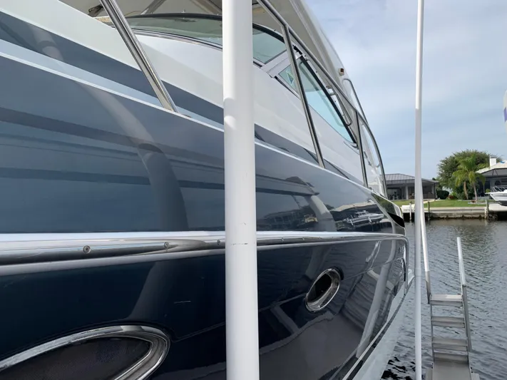 The Great Escape Yacht Photos Pics 2017 Formula 34 Cruiser docked at marina, side view.