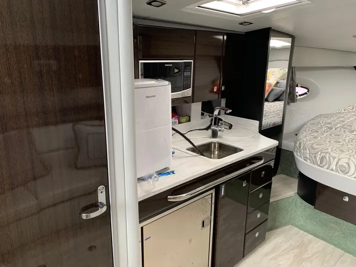 The Great Escape Yacht Photos Pics Interior of 2017 Formula 34 Cruiser with kitchenette and bed.