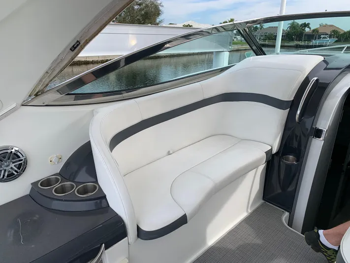 The Great Escape Yacht Photos Pics 2017 Formula 34 Cruiser interior seating with cup holders and waterfront view.