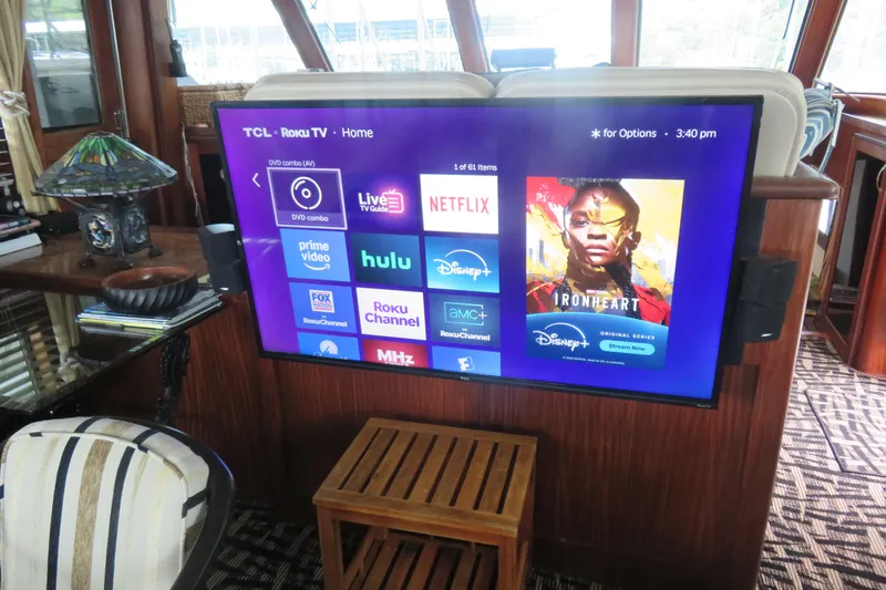 Rive' Gauche Yacht Photos Pics TCL Roku TV in 1986 Hatteras 58 Motor Yacht interior, displaying streaming apps.