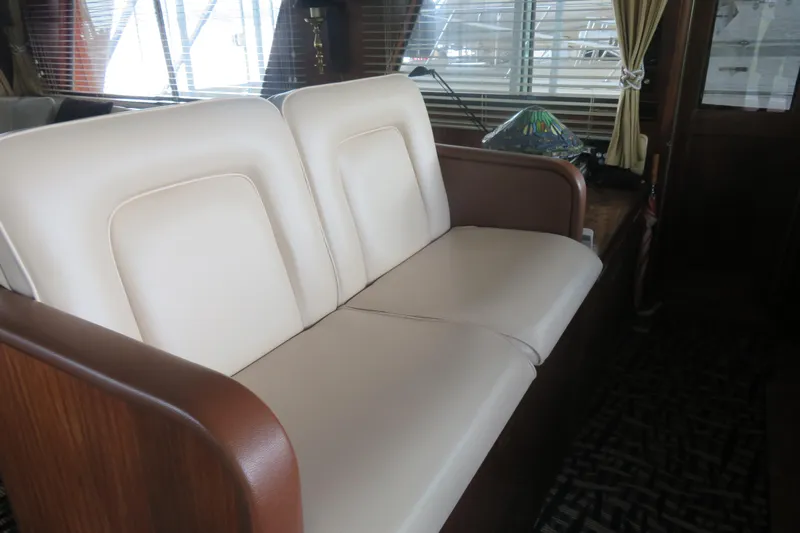 Rive' Gauche Yacht Photos Pics Interior of 1986 Hatteras 58 Motor Yacht with cream leather seating and wooden accents.