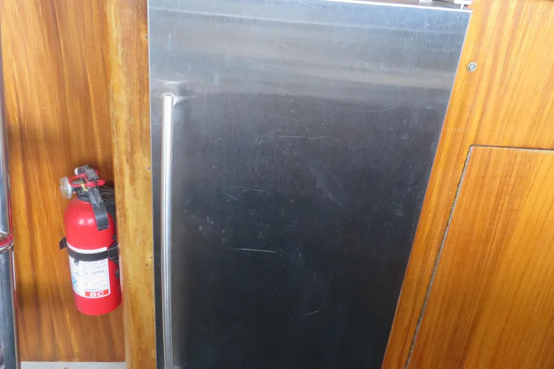 Rive' Gauche Yacht Photos Pics Fire extinguisher and metal panel on 1986 Hatteras 58 Motor Yacht interior.