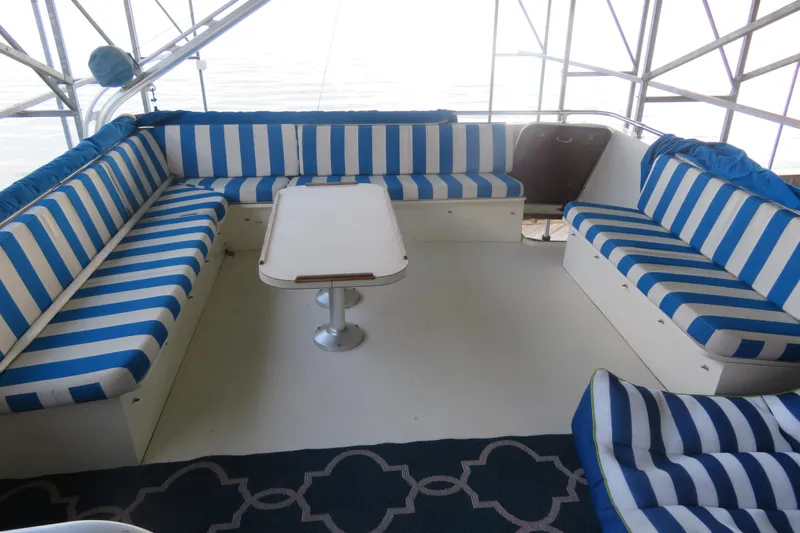 Rive' Gauche Yacht Photos Pics Interior of 1986 Hatteras 58 Motor Yacht with striped seating and table.