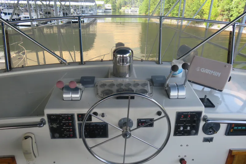Rive' Gauche Yacht Photos Pics Helm of 1986 Hatteras 58 Motor Yacht with steering wheel and navigation equipment.