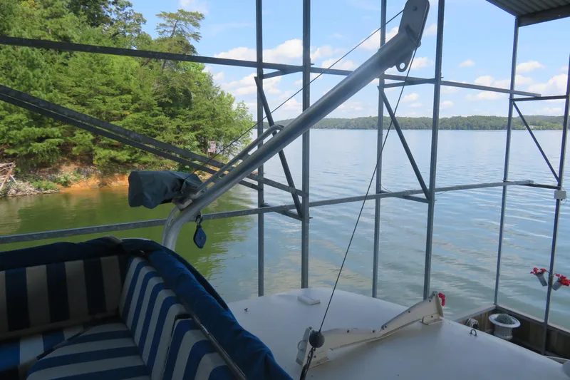 Rive' Gauche Yacht Photos Pics 1986 Hatteras 58 Motor Yacht docked by a scenic lake with lush greenery.