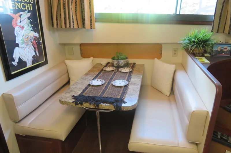 Rive' Gauche Yacht Photos Pics Cozy dining area in 1986 Hatteras 58 Motor Yacht with elegant decor and seating.