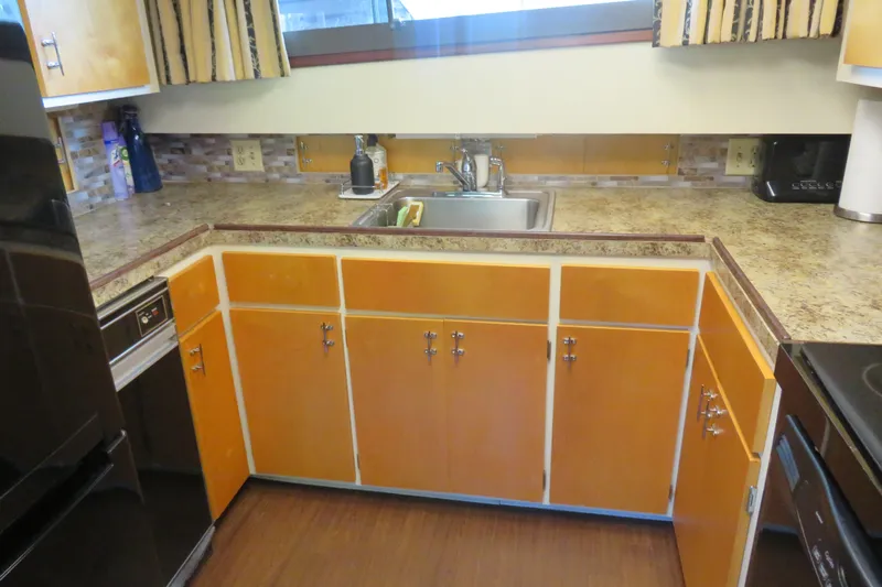 Rive' Gauche Yacht Photos Pics 1986 Hatteras 58 Motor Yacht kitchen with wooden cabinets and stainless steel sink.