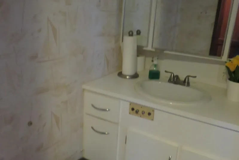 Rive' Gauche Yacht Photos Pics Bathroom vanity in 1986 Hatteras 58 Motor Yacht with sink, faucet, and floral decor.