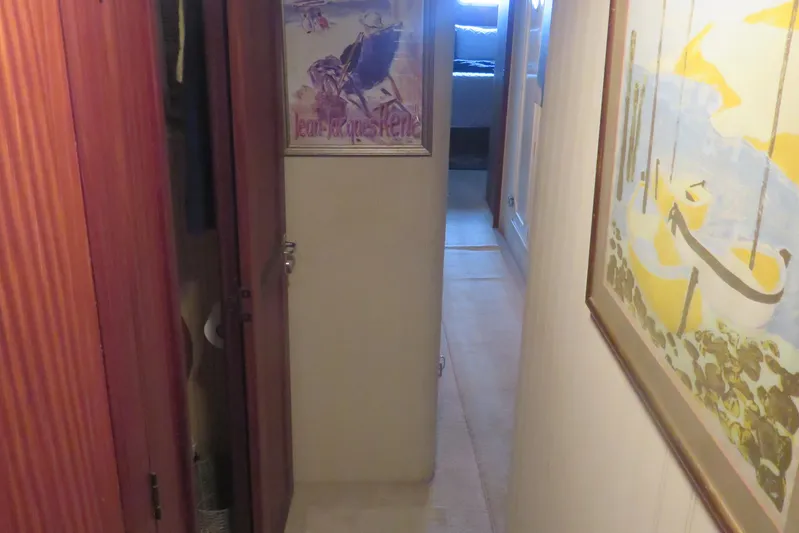 Rive' Gauche Yacht Photos Pics Hallway inside 1986 Hatteras 58 Motor Yacht with artwork and wooden cabinetry.