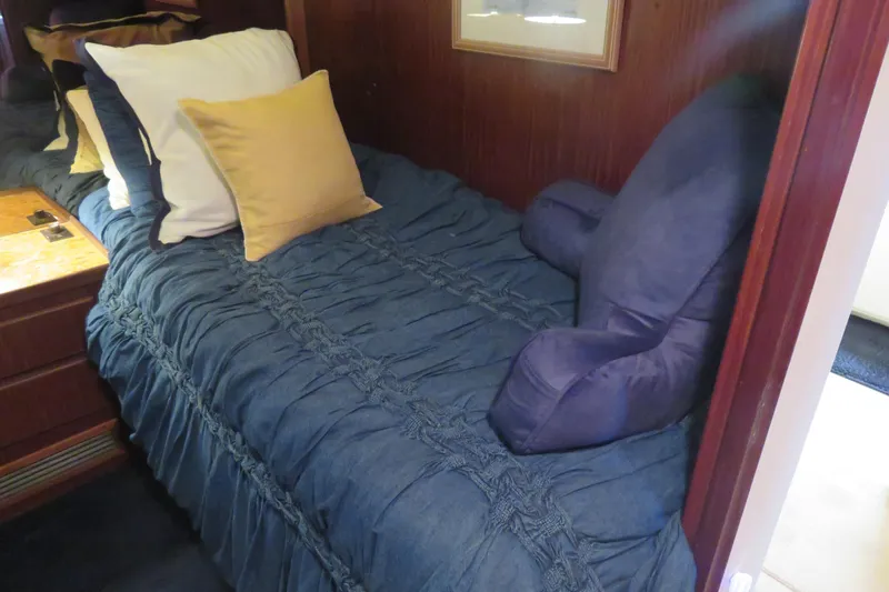 Rive' Gauche Yacht Photos Pics Cozy cabin bed with blue bedding on 1986 Hatteras 58 Motor Yacht.