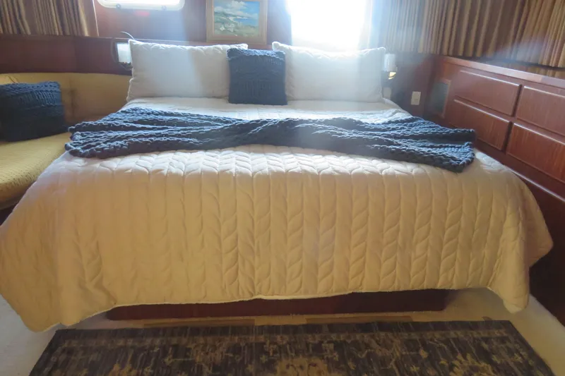 Rive' Gauche Yacht Photos Pics Cozy bedroom interior of 1986 Hatteras 58 Motor Yacht with elegant bedding.
