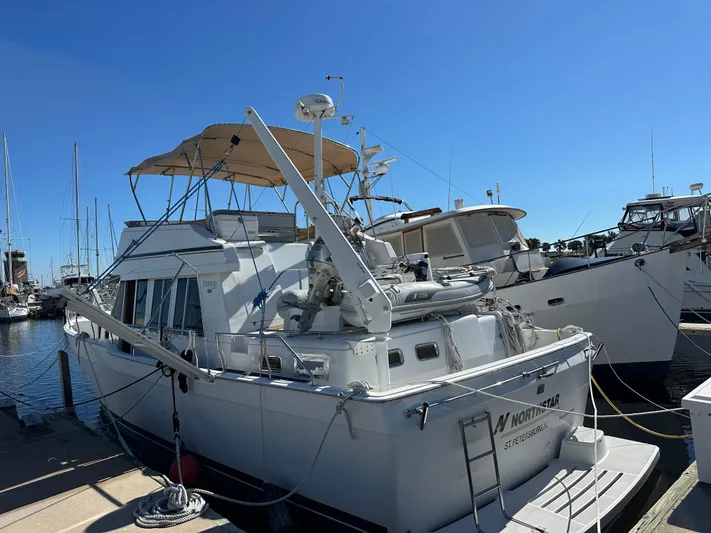 Northstar Yacht Photos Pics 2002 Mainship 430 Trawler docked at marina under clear blue sky.