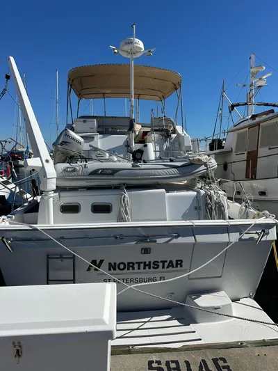 Northstar Yacht Photos Pics 2002 Mainship 430 Trawler docked, featuring a dinghy and canopy, labeled "NORTHSTAR" from St. Petersburg, FL.