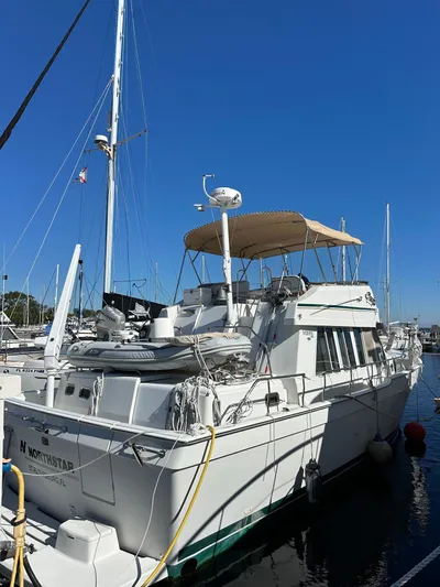 Northstar Yacht Photos Pics 2002 Mainship 430 Trawler docked at marina under clear blue sky.