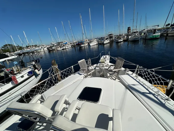 Northstar Yacht Photos Pics 2002 Mainship 430 Trawler docked in a marina with sailboats in the background.