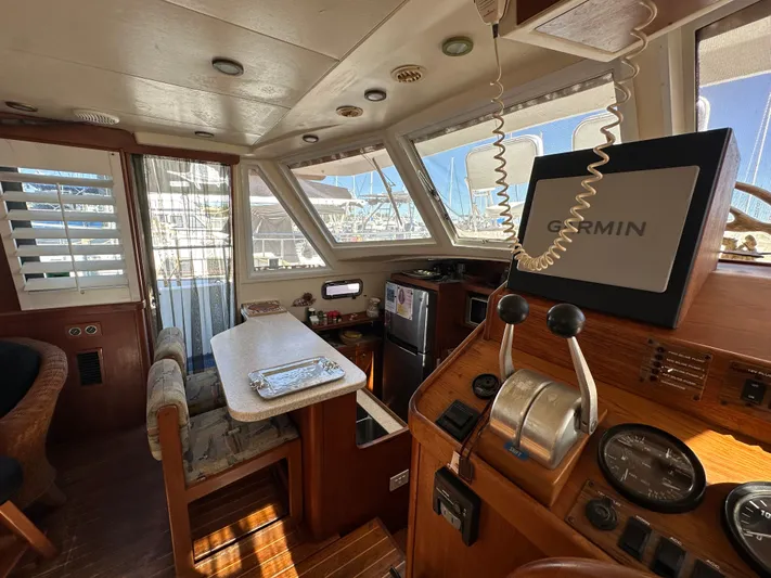 Northstar Yacht Photos Pics Interior of 2002 Mainship 430 Trawler with helm, dining area, and navigation equipment.