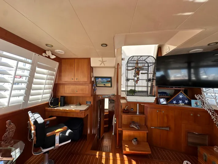 Northstar Yacht Photos Pics Interior of 2002 Mainship 430 Trawler with wooden cabinetry, desk, and birdcage.