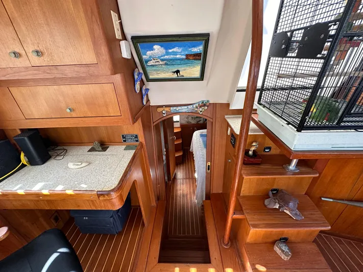 Northstar Yacht Photos Pics Interior of 2002 Mainship 430 Trawler with wooden cabinetry and stairs, featuring nautical decor.