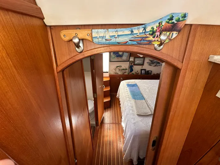 Northstar Yacht Photos Pics 2002 Mainship 430 Trawler cabin interior with wooden decor and cozy bedroom.