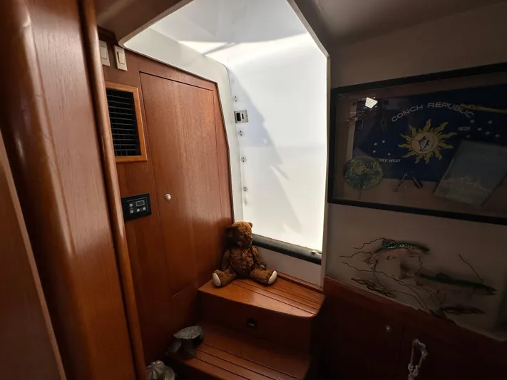 Northstar Yacht Photos Pics 2002 Mainship 430 Trawler interior with wooden paneling, window, and decorative elements.