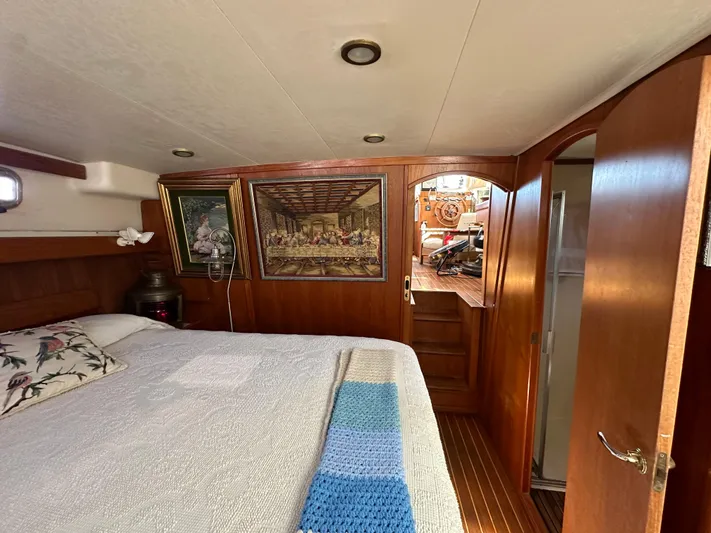 Northstar Yacht Photos Pics Cozy cabin interior of 2002 Mainship 430 Trawler with bed, artwork, and wooden decor.