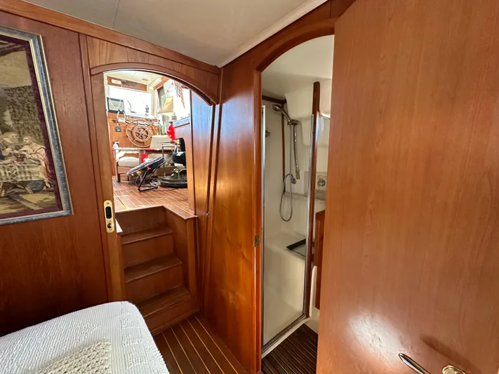 Northstar Yacht Photos Pics 2002 Mainship 430 Trawler interior with wooden finish, showing stairs and bathroom.