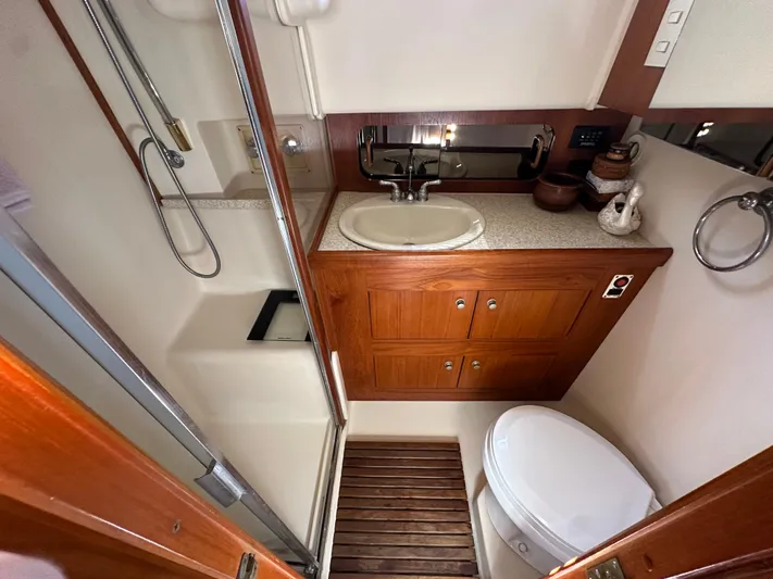 Northstar Yacht Photos Pics Bathroom interior of 2002 Mainship 430 Trawler with wooden cabinetry and modern fixtures.
