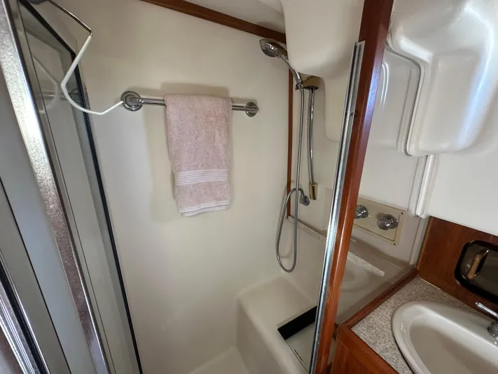 Northstar Yacht Photos Pics Bathroom in 2002 Mainship 430 Trawler with shower, towel rack, and sink.
