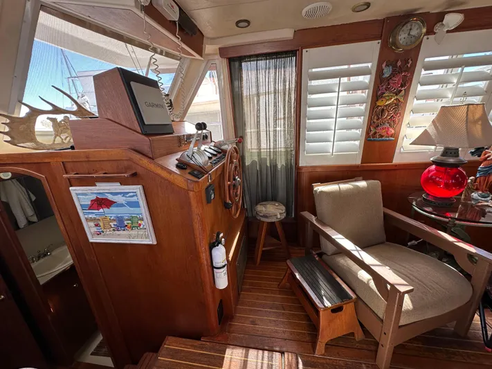 Northstar Yacht Photos Pics 2002 Mainship 430 Trawler interior with wooden helm, seating, and nautical decor.