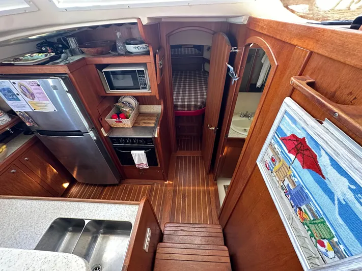 Northstar Yacht Photos Pics 2002 Mainship 430 Trawler interior with kitchen, microwave, and cozy cabin.