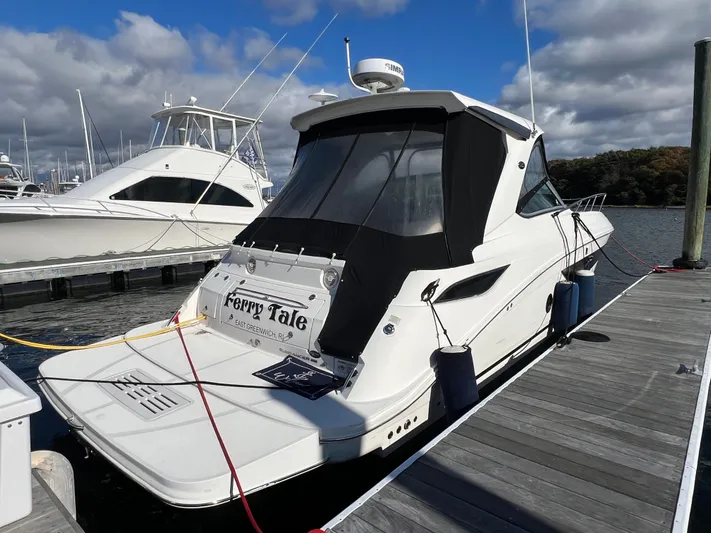  Yacht Photos Pics 2018 Sea Ray 350 Sundancer docked, featuring sleek design and black canopy.