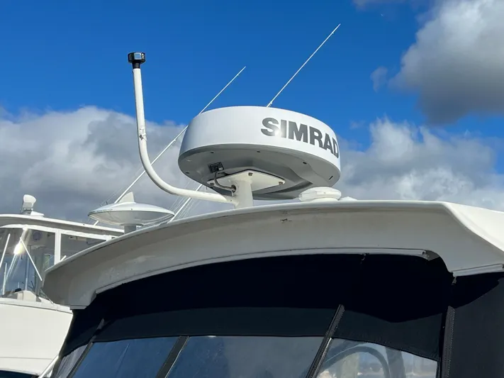  Yacht Photos Pics 2018 Sea Ray 350 Sundancer with Simrad radar against a cloudy sky.