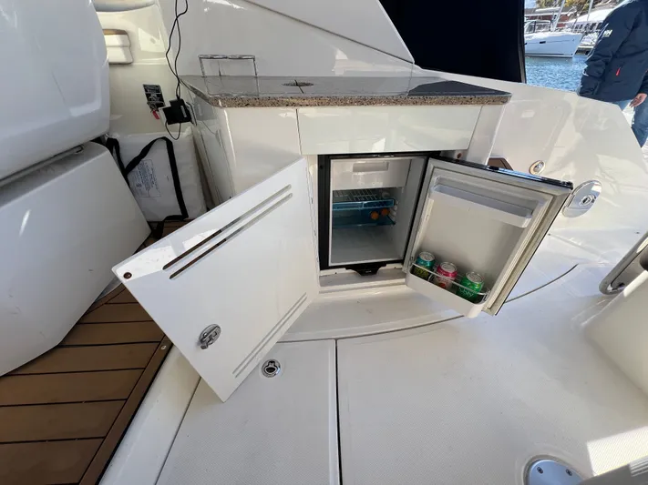  Yacht Photos Pics 2018 Sea Ray 350 Sundancer boat with open mini fridge and storage compartment.